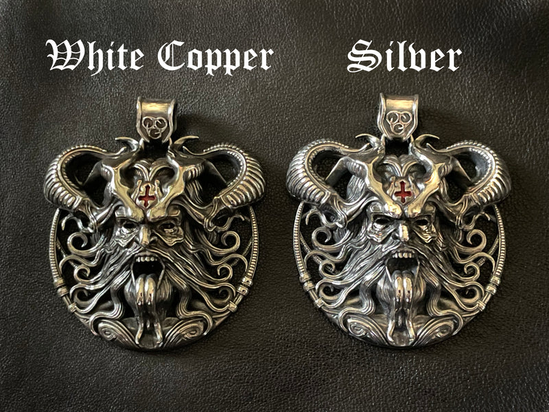 A front view comparing the "Banished by Sin" Devil's Amulet in both White Copper and Sterling Silver finishes, showcasing the color contrast and shared intricate design.